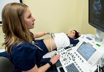 Medical Imaging student working with patient